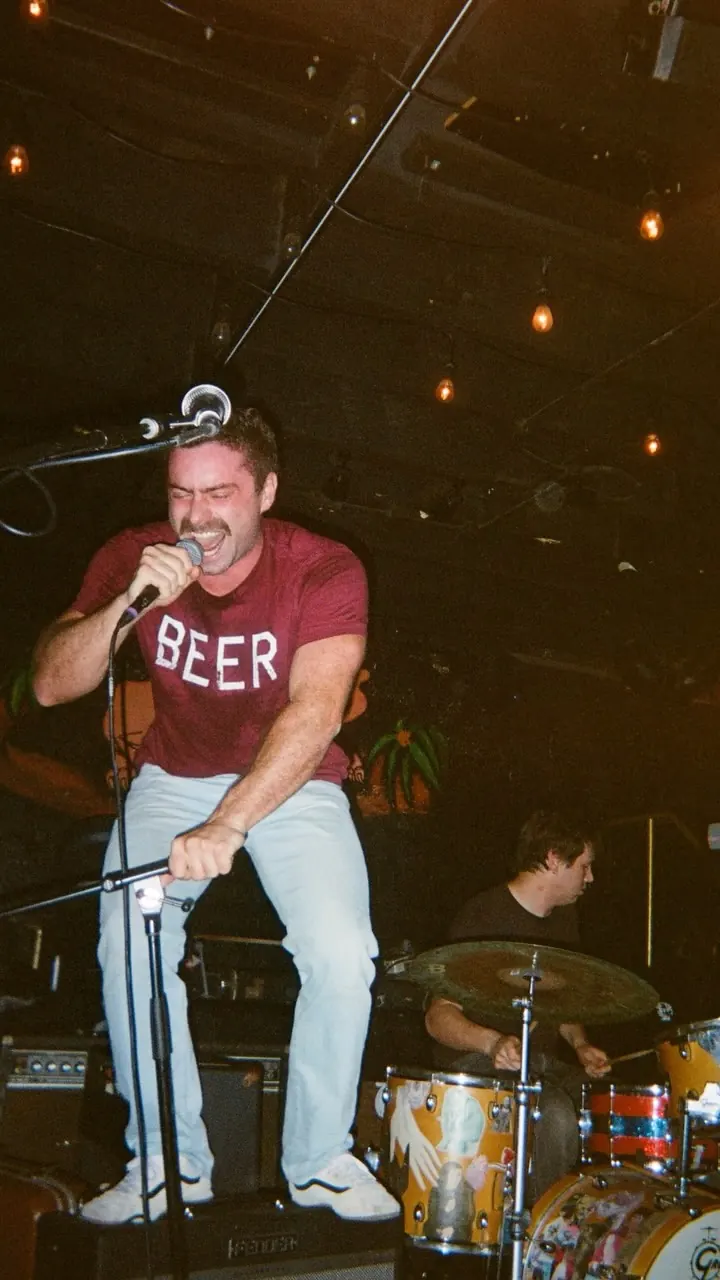 A singer in a BEER shirt at NoSurf Casbah
