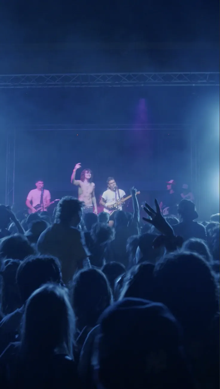 A crowd in blue stage light